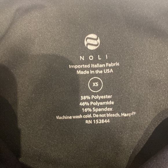 These are black leggings with a green streak and a star on both sides - Picture 3 of 3